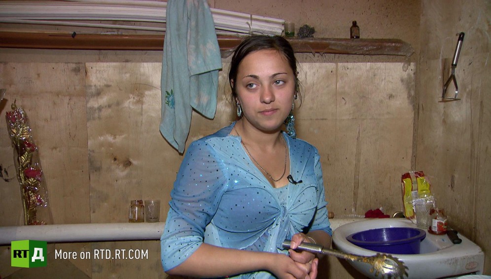 Kalderash Gypsy teenager Cassandra is doing the washing up